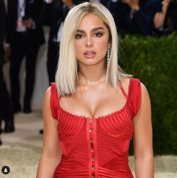 Addison Rae, a woman in a red dress posing for a picture at a Quinceanera