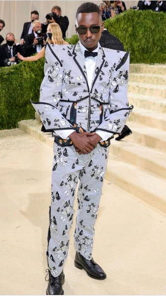 Ashton Sanders, a man in a suit and bow tie, at a Quinceanera celebration