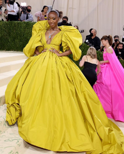 Andrew Bolton wearing met gala outfit 21, posing for a picture in a yellow Quinceanera dress