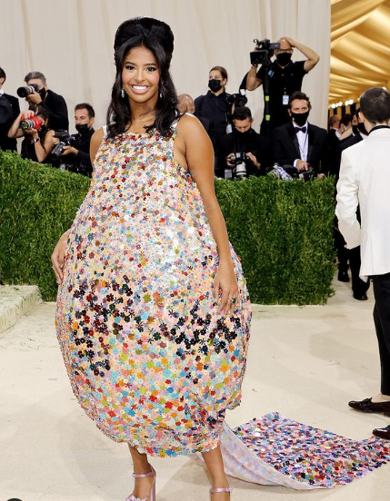 Natalia Diamante Bryant, a woman in a sequinized Quinceanera dress poses for the camera