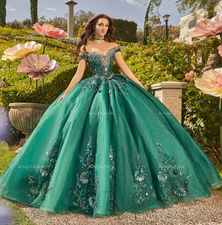 A Quinceañera dress ev32 632. A woman in a green dress standing in a garden.